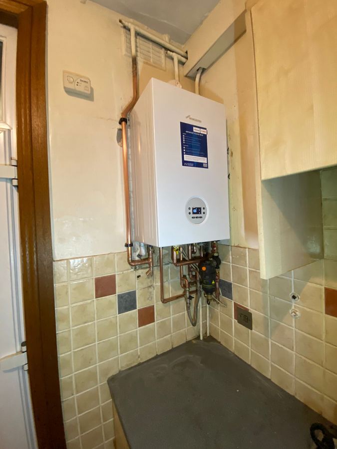 Worcester Bosch combi boiler installed in a utility room with a magnetic system filter